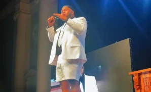 druski live on stage in white suite and shorts
