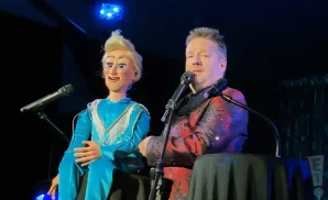 terry fator performing on stage with puppet