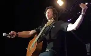 joe nichols pointing microphone towards crowd at the hammond stadium in fort myers, florida.
