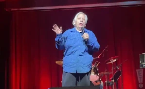 john conlee singing live in front of red backdrop