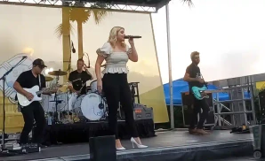 lauren alaina performs on stage wearing a white blouse
