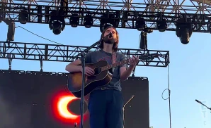 mt joy singer performing on stage while playing the guitar