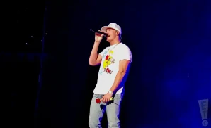 parker mccollum performing on stage while holding a rose