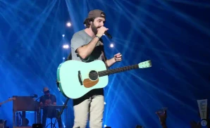 thomas rhett performing on stage with a blue guitar