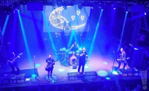 currents performing on stage in blue lighting