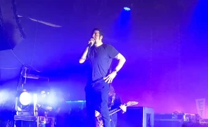 deftones singer singing in front of blue lights