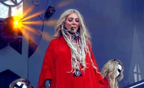 in this moment singer wearing red dress looking down below
