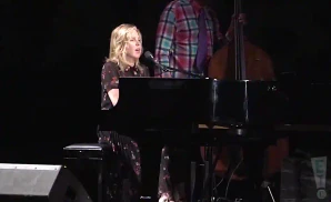 diana krall performing the song the look of love live on a dim lit stage
