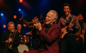 Musicians playing instruments on a stage with colorful lights.
