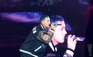 blessd singing on stage while wearing a jersey