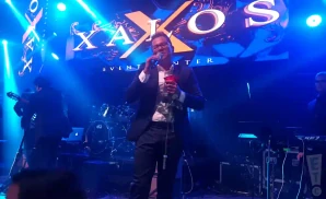 charlie zaa performing on stage under blue lights