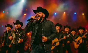 A band performs on stage under colorful lights. The lead singer wears a cowboy hat and sings into a microphone.