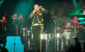 pepe aguilar performing on stage in matador clothing.