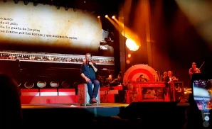 ricardo arjona sits on stage performing in madrid spain