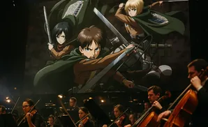 An orchestra plays in front of a large screen displaying characters from the anime Attack on Titan.