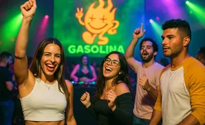 Young adults dancing and smiling at a nightclub with a 