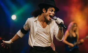 Michael Jackson impersonator singing into a microphone on stage.