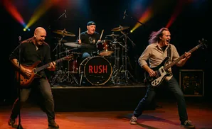 Geddy Lee, Alex Lifeson, and Neil Peart of Rush perform live.