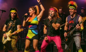 Band members performing on stage in colorful 80s-inspired outfits.