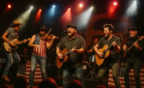 A band performs on stage, with musicians playing guitar, violin, and bass.