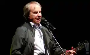 chris de burgh performing on stage at the royal concert hall in glasgow, scotland.