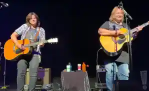 indigo girls duo performing on stage both playing the guitar.