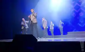 straight no chaser members on stage under blue lights