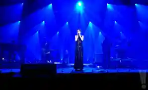 zaz singing live in munich, germany under blue lights.