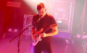 between the buried and me singer singing and playing the electric guitar