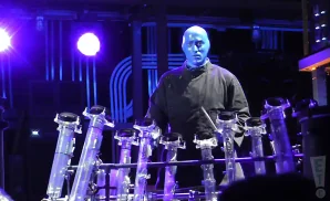 blue man group member live on stage wearing all black.