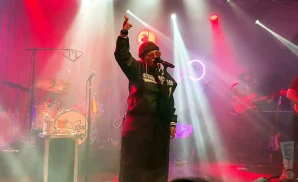 elle king performing on stage with red lights in background