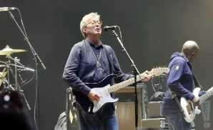 eric clapton playing guitiar besides band member