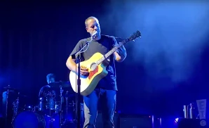 jack johnson performing at the hollywood bowl in a black shirt