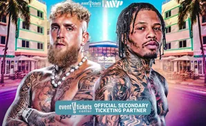 Two tattooed boxers, Jake Paul and Gervonta Davis, pose in front of a Miami-like cityscape.