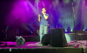 oar singer singing on stage in front of purple fog