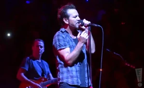 pearl jam singer and electric guitarist performing on stage