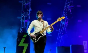 the strokes bass player playing with dark shades on