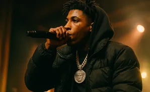 YoungBoy Never Broke Again rapping into a microphone on stage.