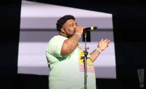 rod wave singing on stage during a live performance at the greensboro coliseum complex