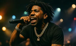 Rapper Ice Spice performs on stage with gold grills and jewelry.