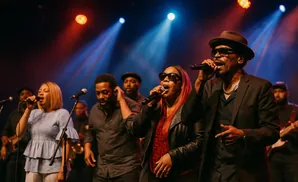 A group of singers perform on stage with microphones and spotlights.