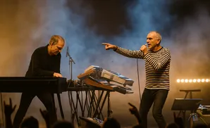 Singer points to keyboardist during a live performance.