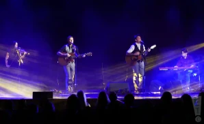 celtic thunder signing and playing guitar during a live perfomance