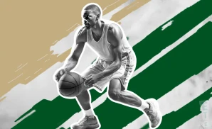 a boston celtics basketball player looks down the court with a basketball in his hand