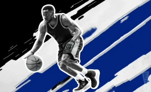 an orlando magic basketball player looks down the court with a basketball in his hand