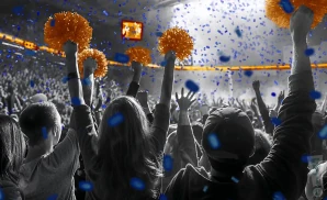 a crowd of cal st. fullerton titans fans cheering for their basketball team