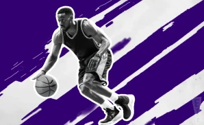 a kansas state wildcats basketball player looking down the court and dribbling the ball