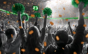 a crowd of miami hurricanes fans cheering for their basketball team