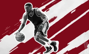 a mississippi state bulldogs basketball player looking down the court and dribbling the ball