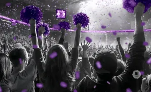 Crowd cheering with purple pom-poms and confetti at a concert.